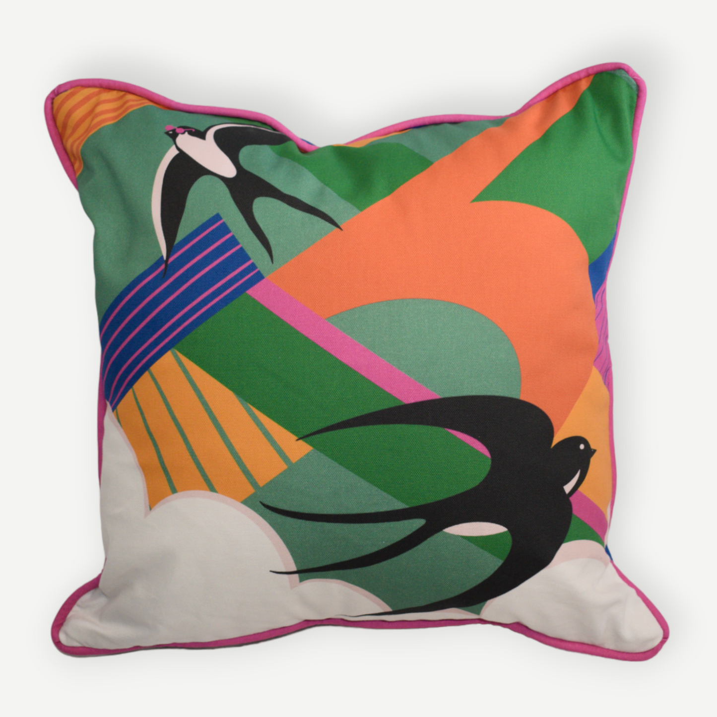 Multicoloured retro style cushion with swallows flying. This cotton cushion has a blue back and pink piping around the edge.