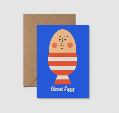Greeting card with a cartoon egg character and 'Good Egg' text on a blue background, accompanied by a brown envelope.