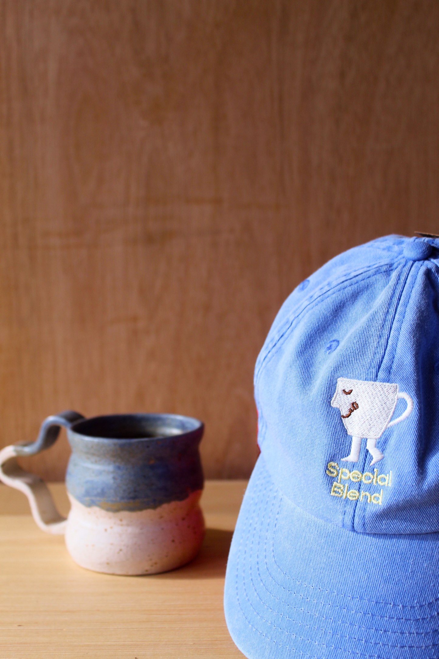 A light blue baseball cap with a white embroidered coffee cup and yellow 'Special Blend' text. Caps for men.