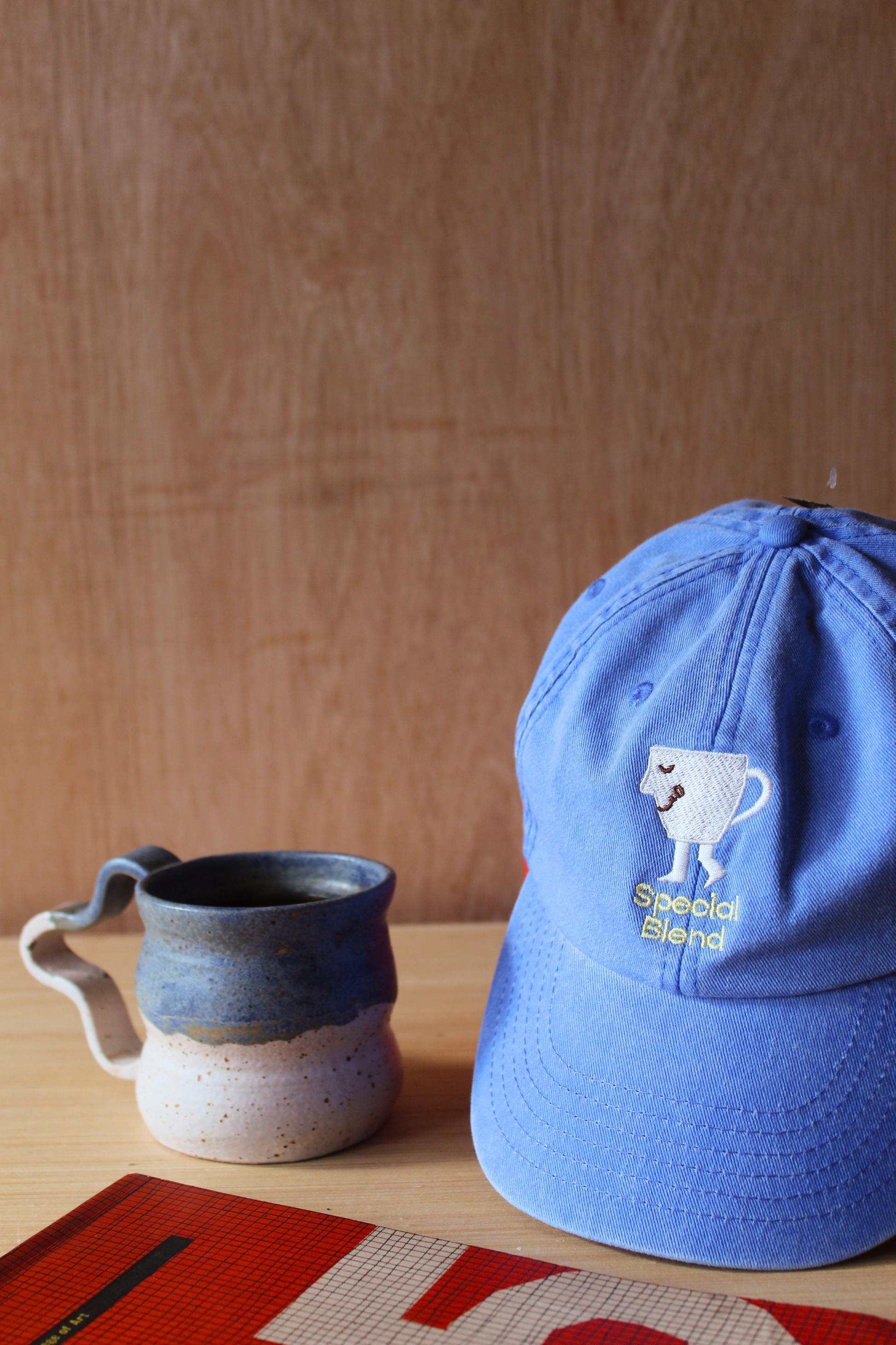 A blue baseball cap with a white embroidered dog logo and the words 'Special Blend'. Men's streetwear. 